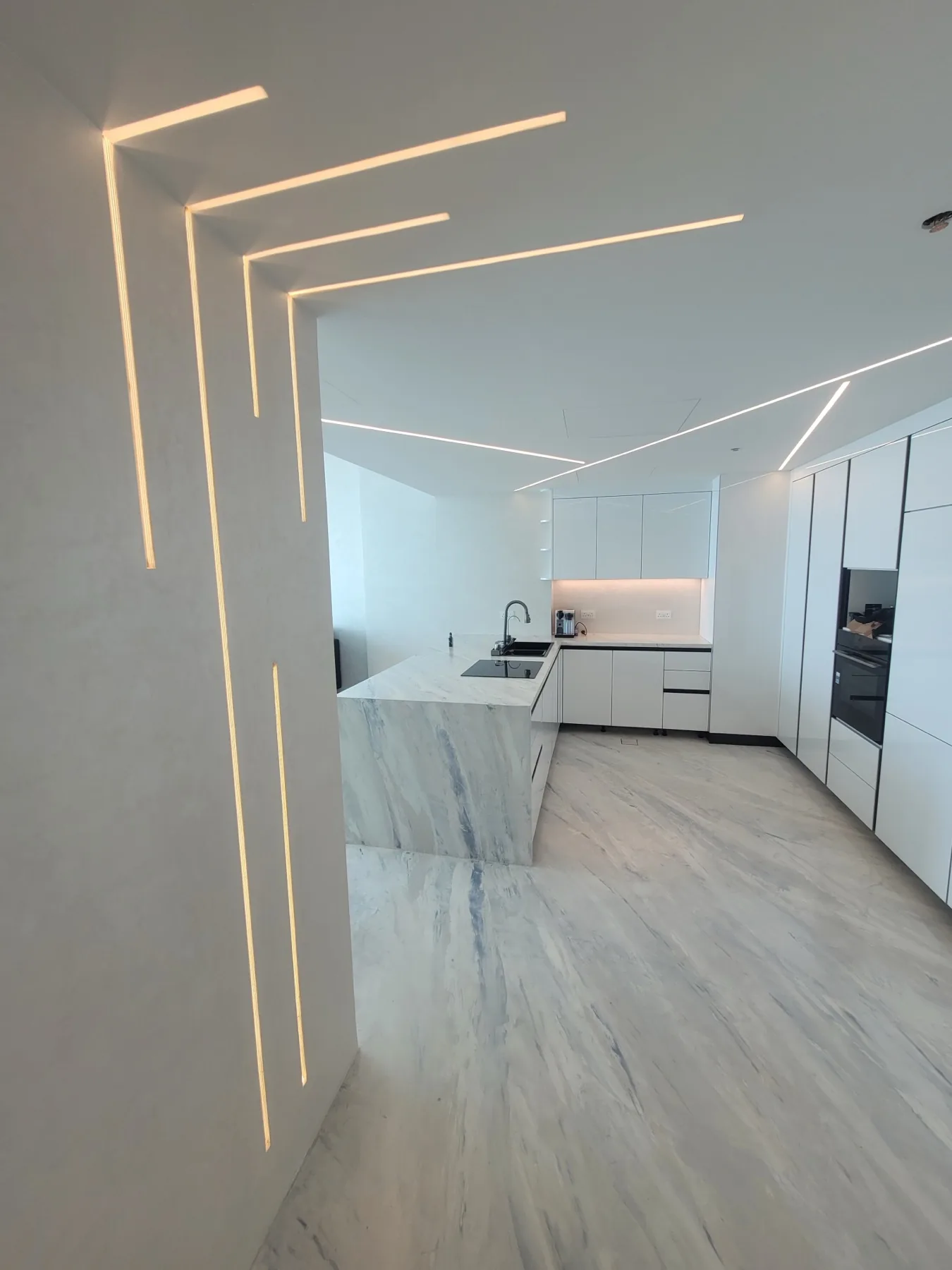 White private residence with continuous mineral finishes and integrated lighting