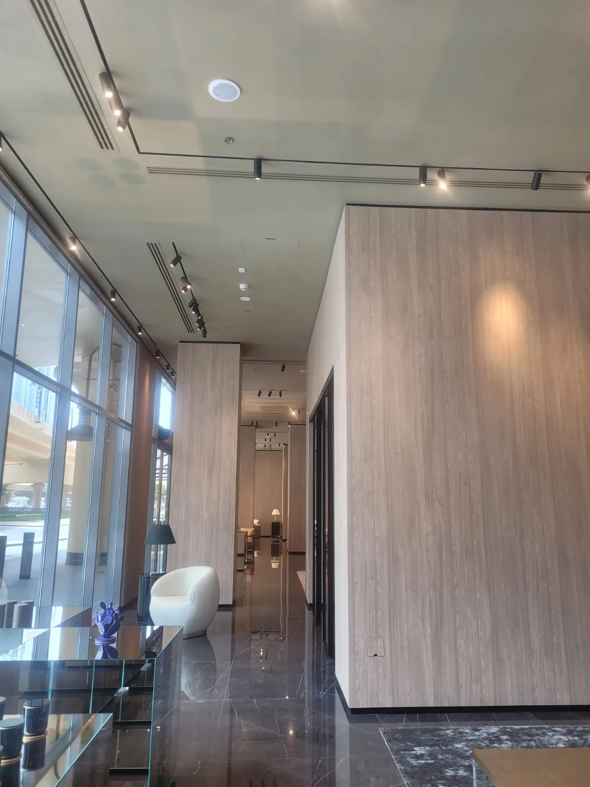 Long luxury showroom gallery with continuous ceiling finish